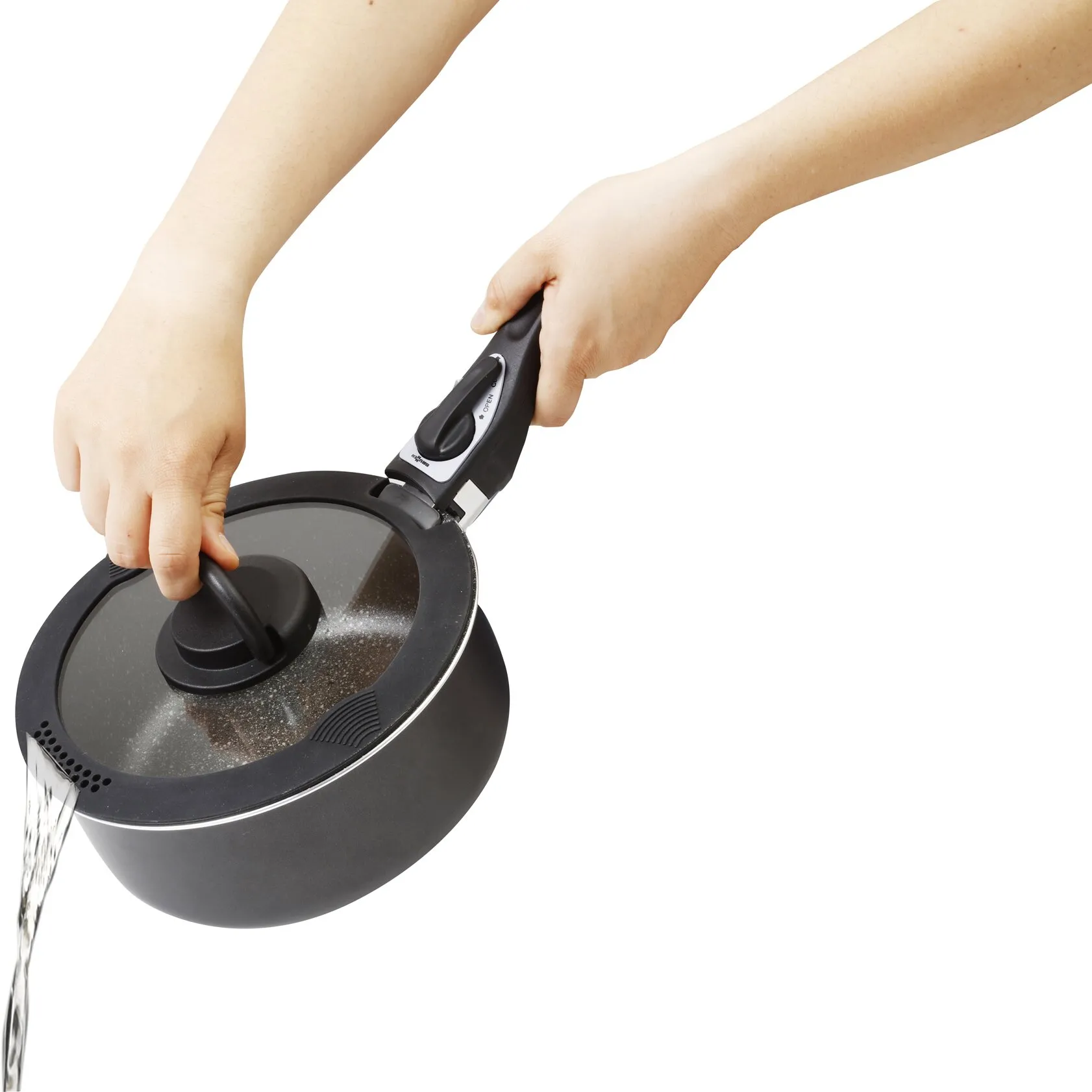 Schwarzer Glasdeckel Covery auf einem Topf, während Wasser durch die integrierte Ausgießöffnung abgegossen wird