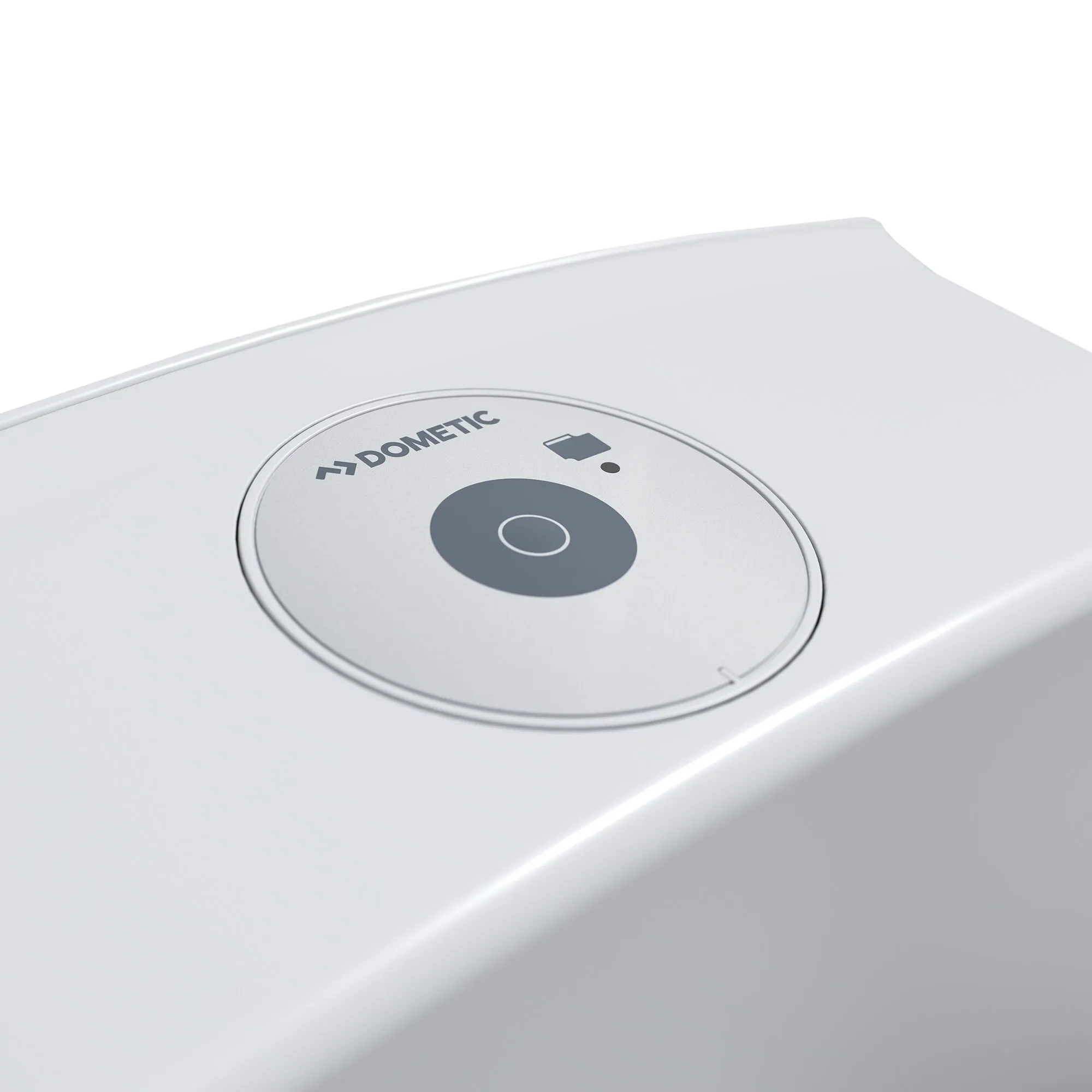 Nahaufnahme der runden Bedieneinheit einer Cassettentoilette CT 4000 CTES 4110, graues Panel mit zentraler Taste und DOMETIC-Logo