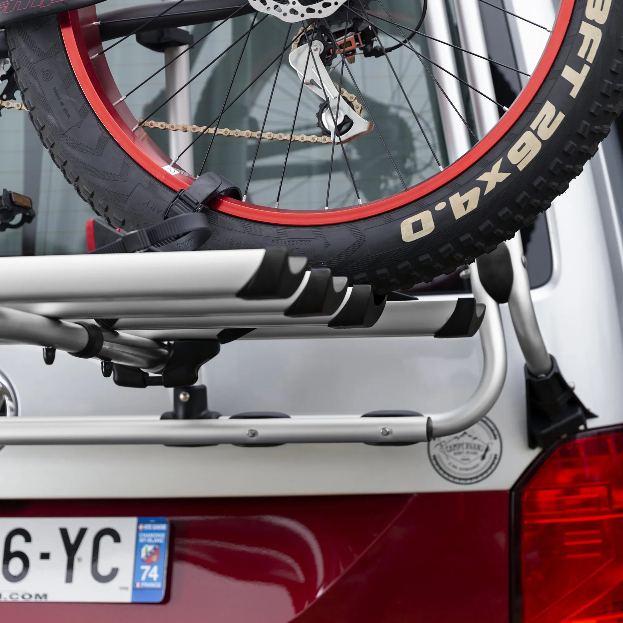 Silberne Fahrradschiene Rail Premium am Autoheck mit befestigtem Mountainbike und schwarzen Spanngurten