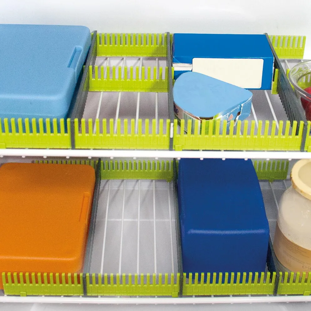 Limefarbene Stauleisten an Kühlschrankböden begrenzen Fächer mit Aufbewahrungsboxen, Dosen und Behältern
