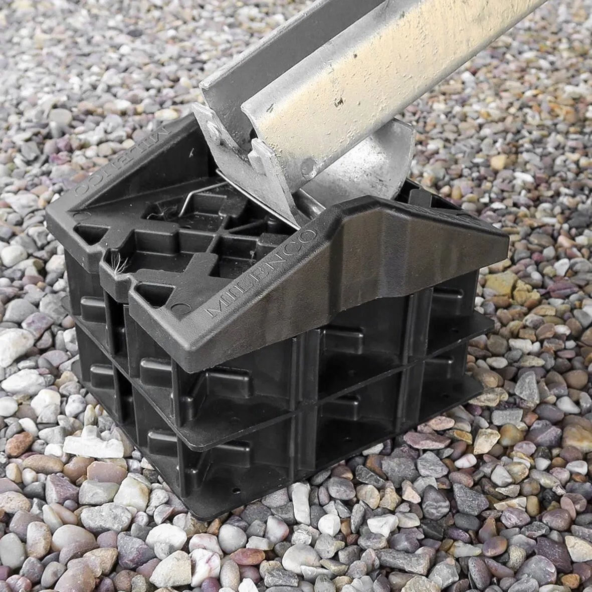 Schwarzes Stützplattenset Corner Feet aus Kunststoff mit eingesetztem Metallprofil auf Kiesuntergrund