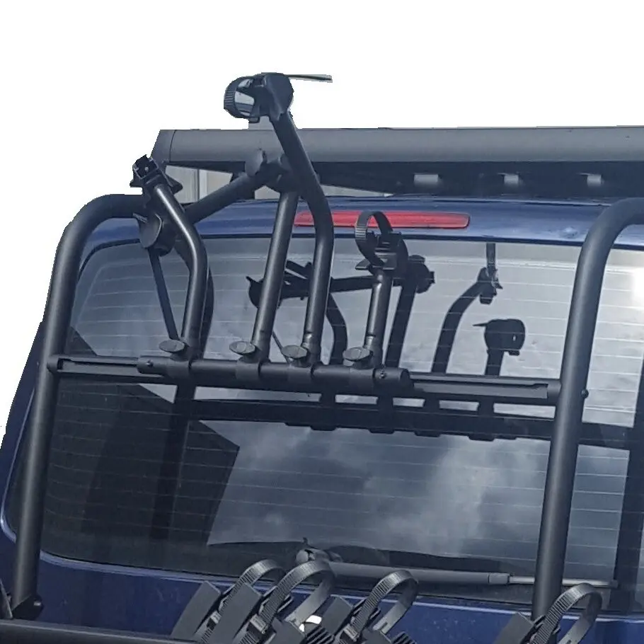 Dunkler Fahrradträger aus Metall mit mehreren Halterarmen an der Heckklappe eines blauen Autos, sichtbar zur Befestigung von Fahrradrahmen