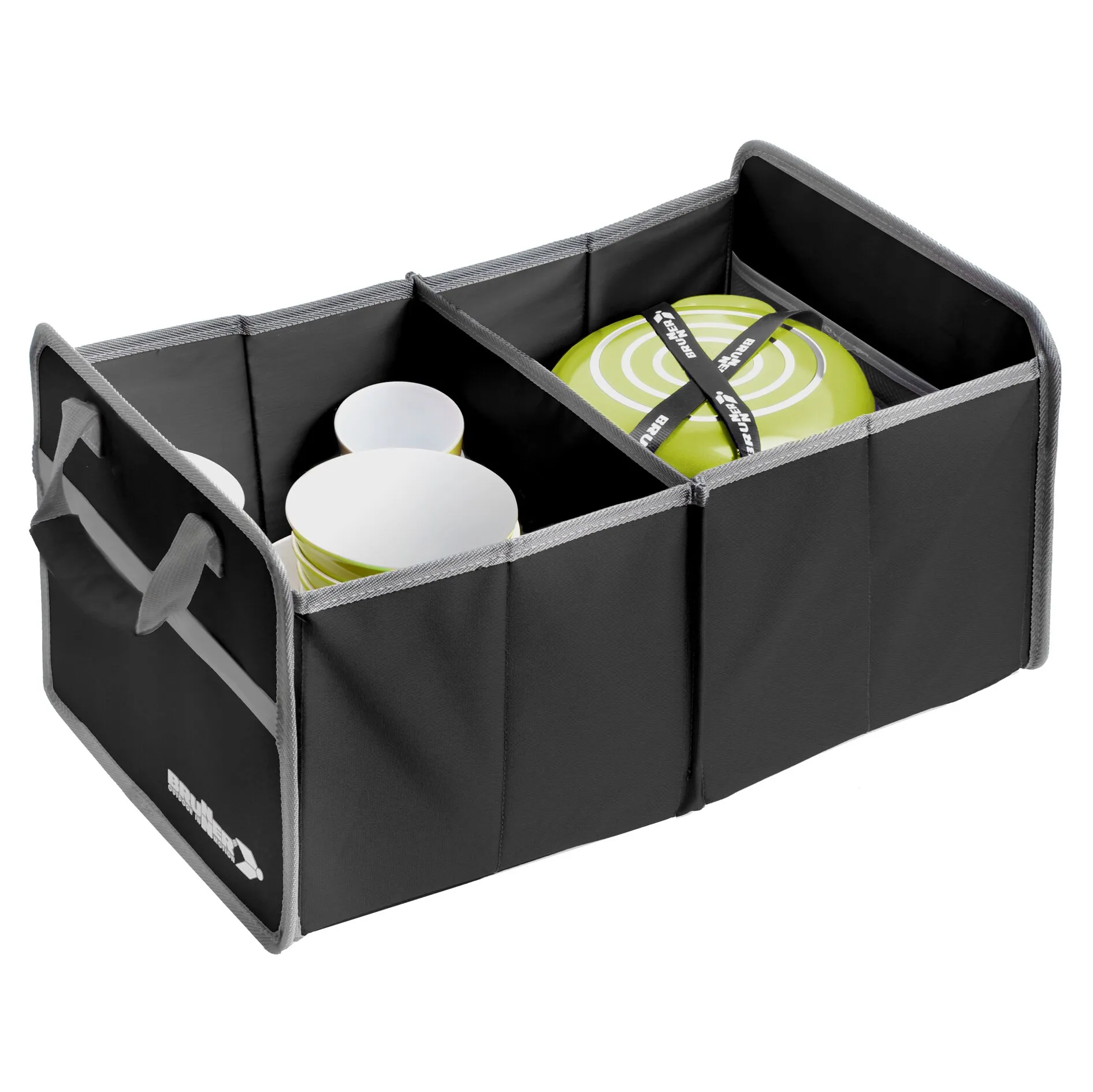 Schwarze Aufbewahrungsbox aus Stoff mit grauen Kanten und drei Fächern, sichtbar sind weiße Teller und Becher sowie ein grün-weißer Deckel mit Ringen